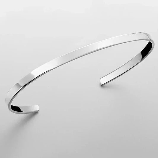 Minimalist silver cuff bracelet with sleek finish on light background, Auretier jewelry