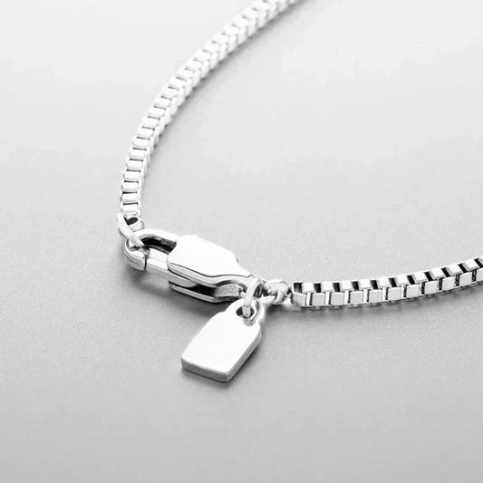 Auretier silver box chain necklace with rectangular pendant and clasp on light background