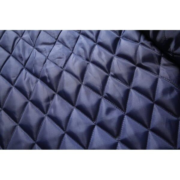 Close-up of dark blue quilted overcoat lining fabric from Auretier