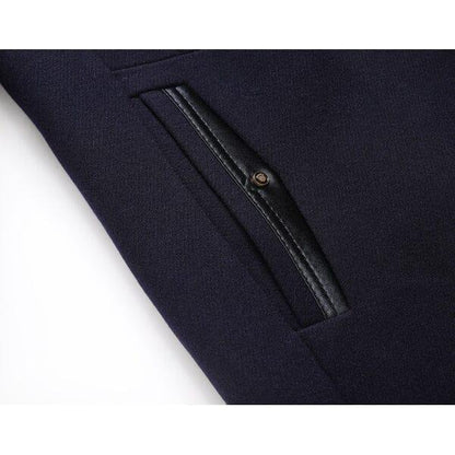 Close-up of dark navy overcoat pocket with black leather trim, Auretier outerwear detail