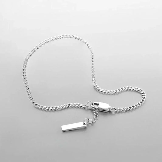 Minimalist silver chain bracelet with a rectangular charm on a white background, Auretier jewelry