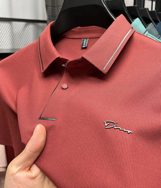 Textured red men's polo shirt with embroidered logo, displayed on hanger at Auretier store