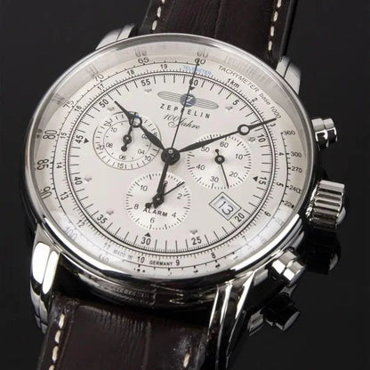 Zeppelin men's chronograph watch with white dial, brown leather strap, and date window on black background