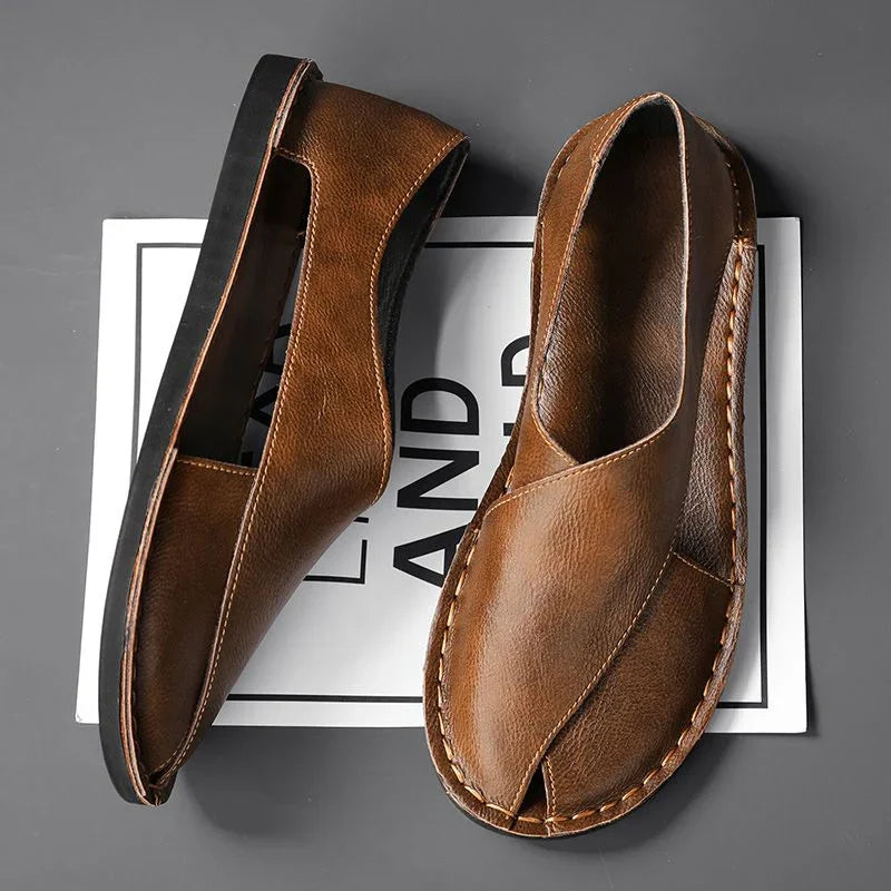 Brown leather sandals with stitched detail on gray background, Auretier footwear style