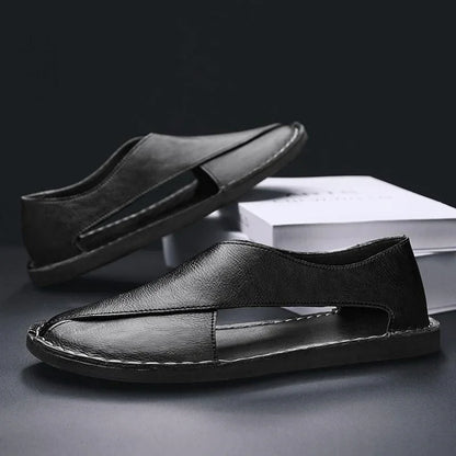 Black leather sandals with cutout design on display, modern footwear by Auretier