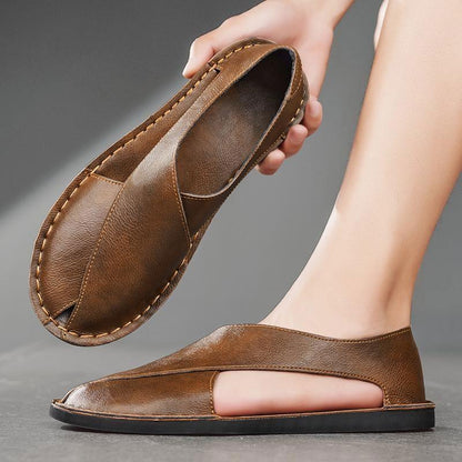 Brown leather sandals with open sides, handmade style, shown on foot and in hand
