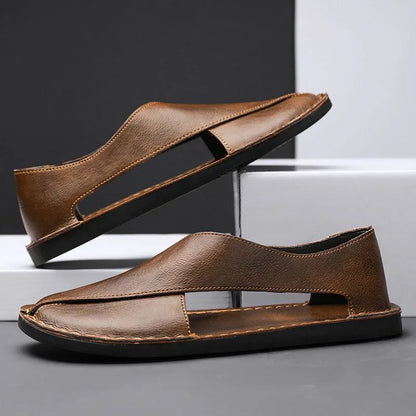 Brown leather sandals with cutout sides, flat soles, displayed on a modern background