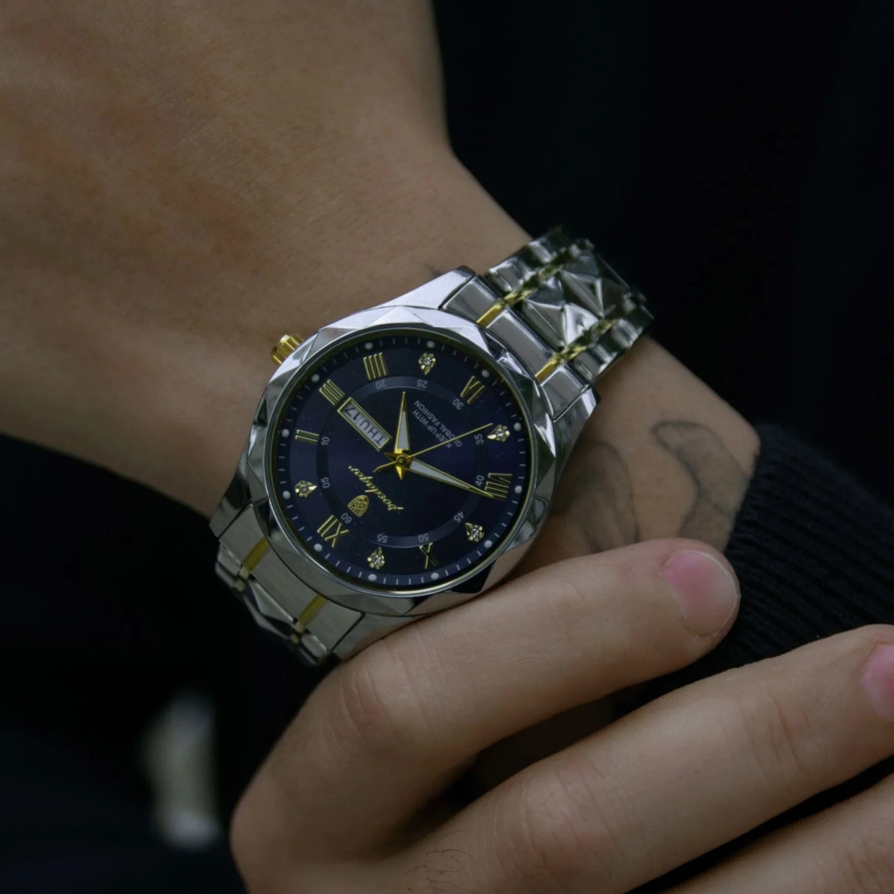 Luxury 40mm steel wristwatch with gold accents and blue dial worn on wrist, Auretier