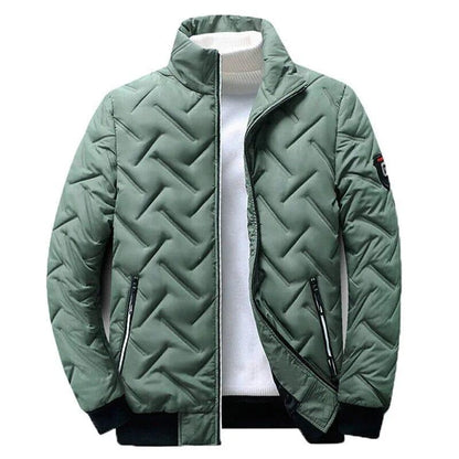 Green quilted urban style transition jacket with zipper pockets, displayed on white top